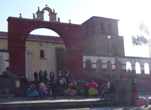 The Church at the village near Chucuito.  The cross out front is the marker of the Inquisition. The dancers are on day four of a wedding celebration